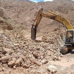 Excavator carrying out trenching work at the Ghor Fifa copper exploration site in Jordan.