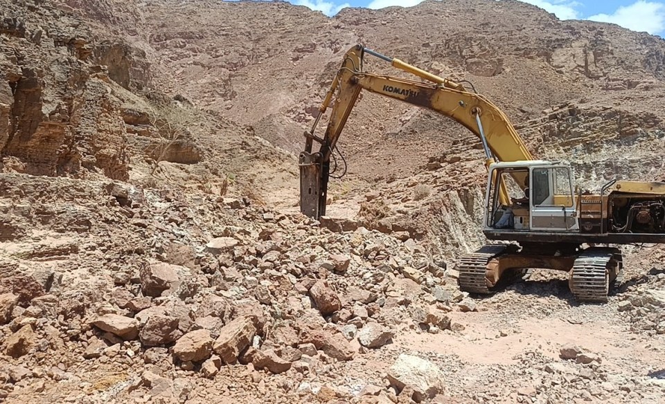 Excavator carrying out trenching work at the Ghor Fifa copper exploration site in Jordan.