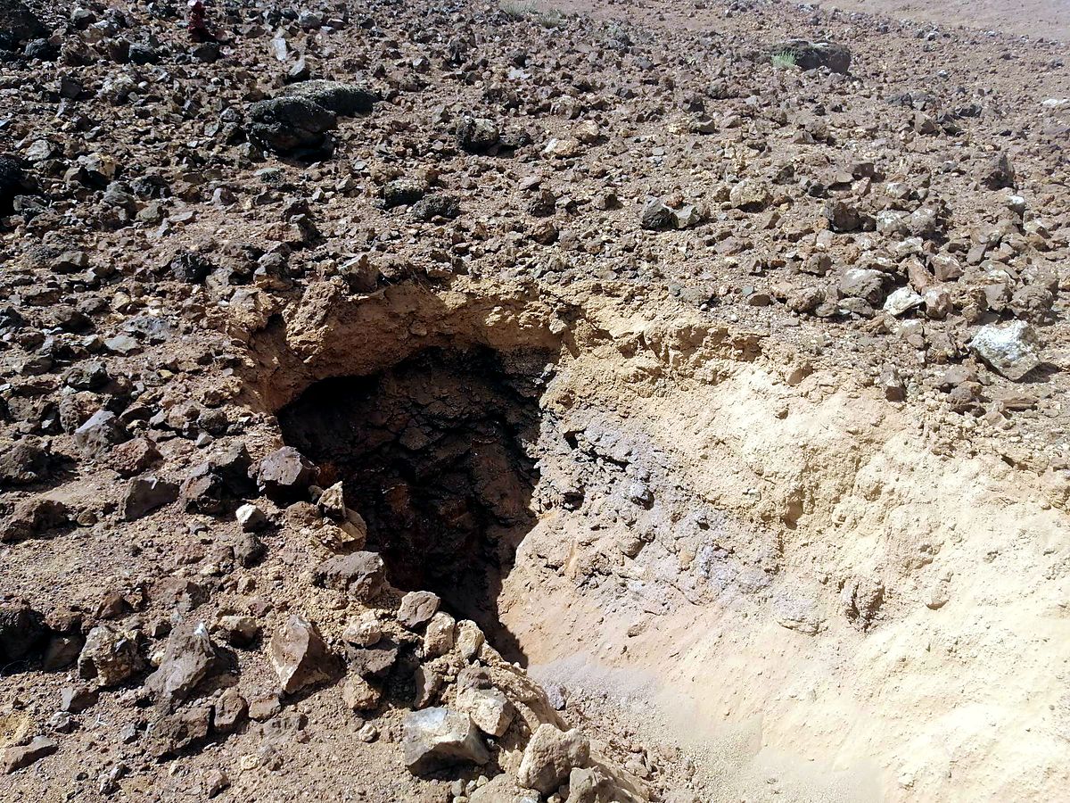 Pale zeolitic tuff exposed just below the ground surface in an exploration trench