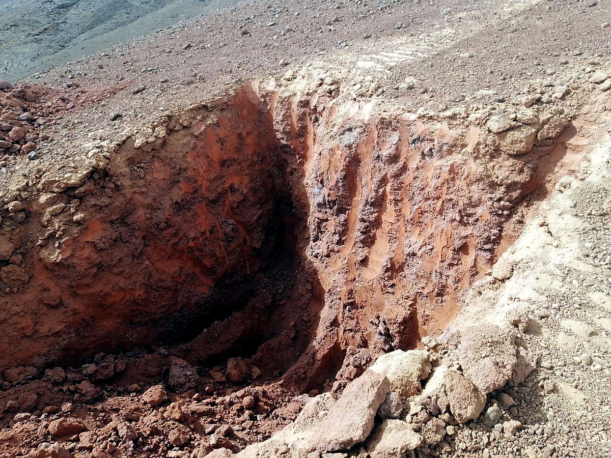 Close view of a trench wall exposing layered zeolitic tuff